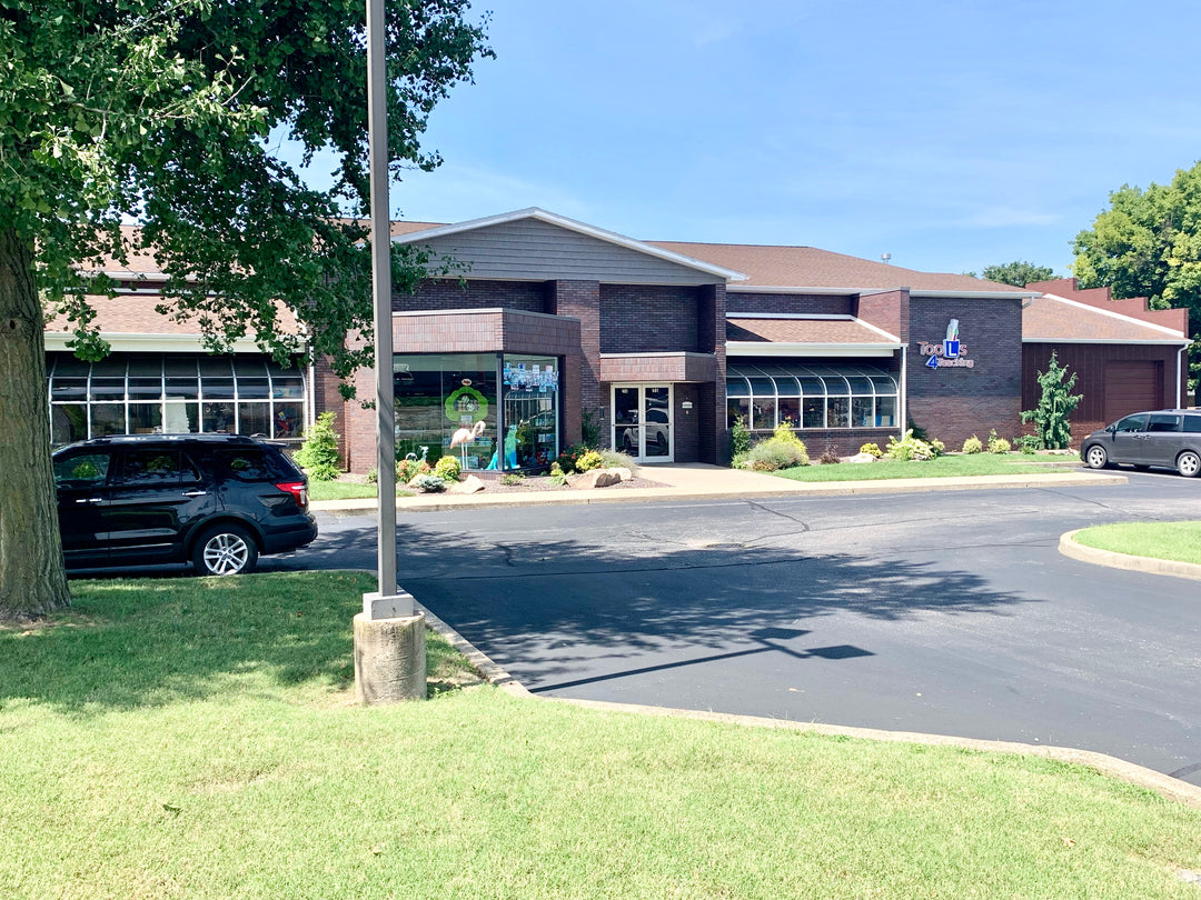 Building exterior with cars parked in front on a sunny day